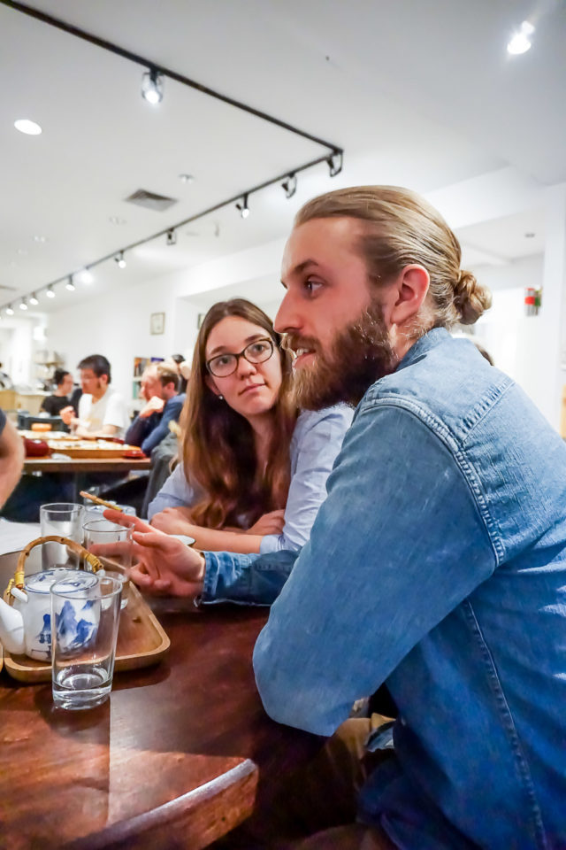 Monica et Nicolas discutant avec d’autres personnes dans le salon de thé.