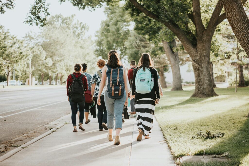 Un groupe d’étudiants avec des sacs à dos marchant sur le campus.