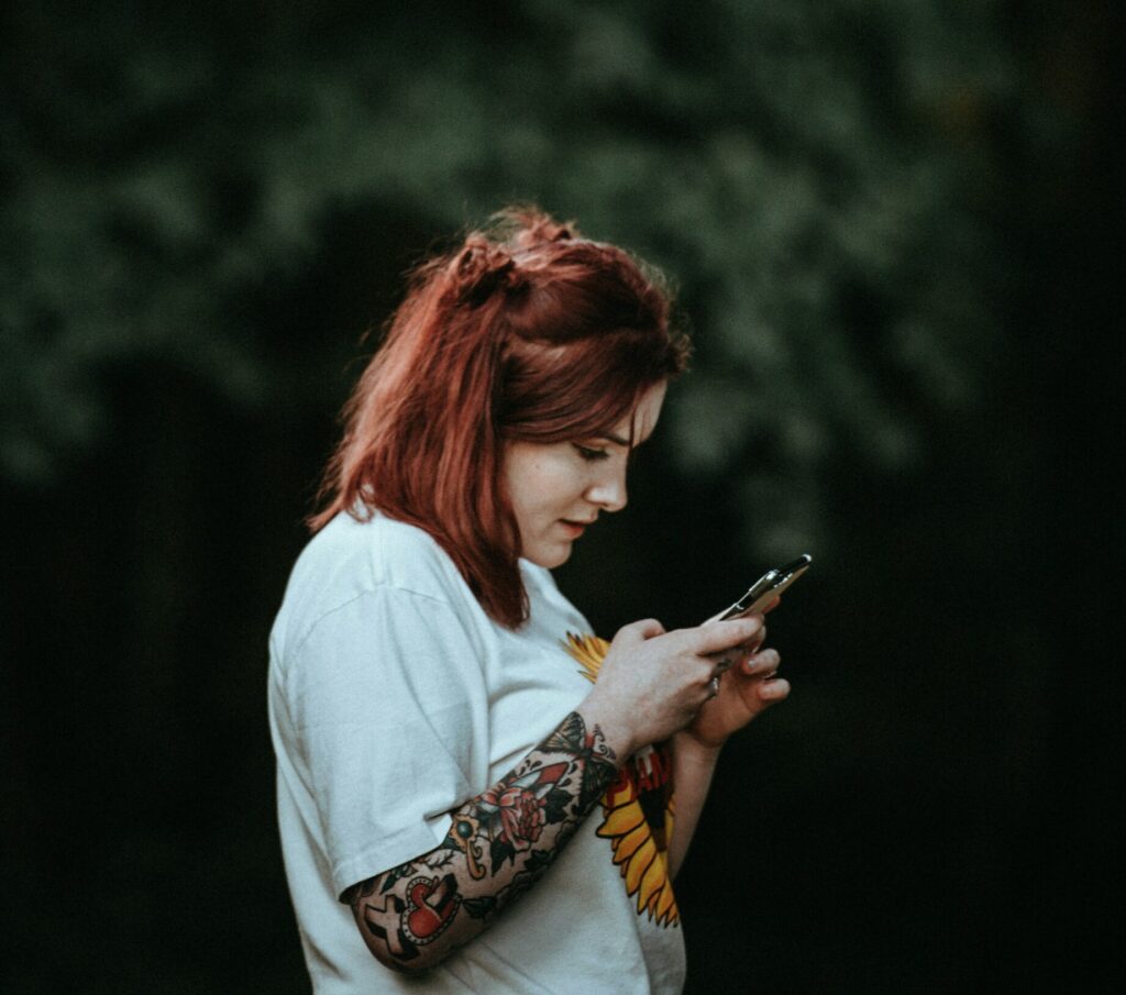 Une femme consultant son téléphone pour des offres d'emploi.